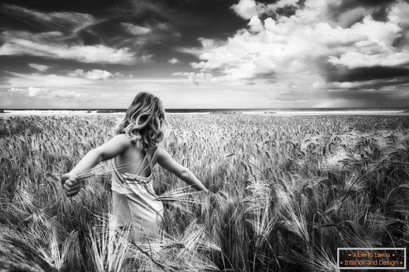 Black and white photo of a girl in a wheat field