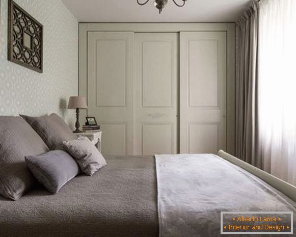 Wooden built-in closet in the bedroom three-leaved