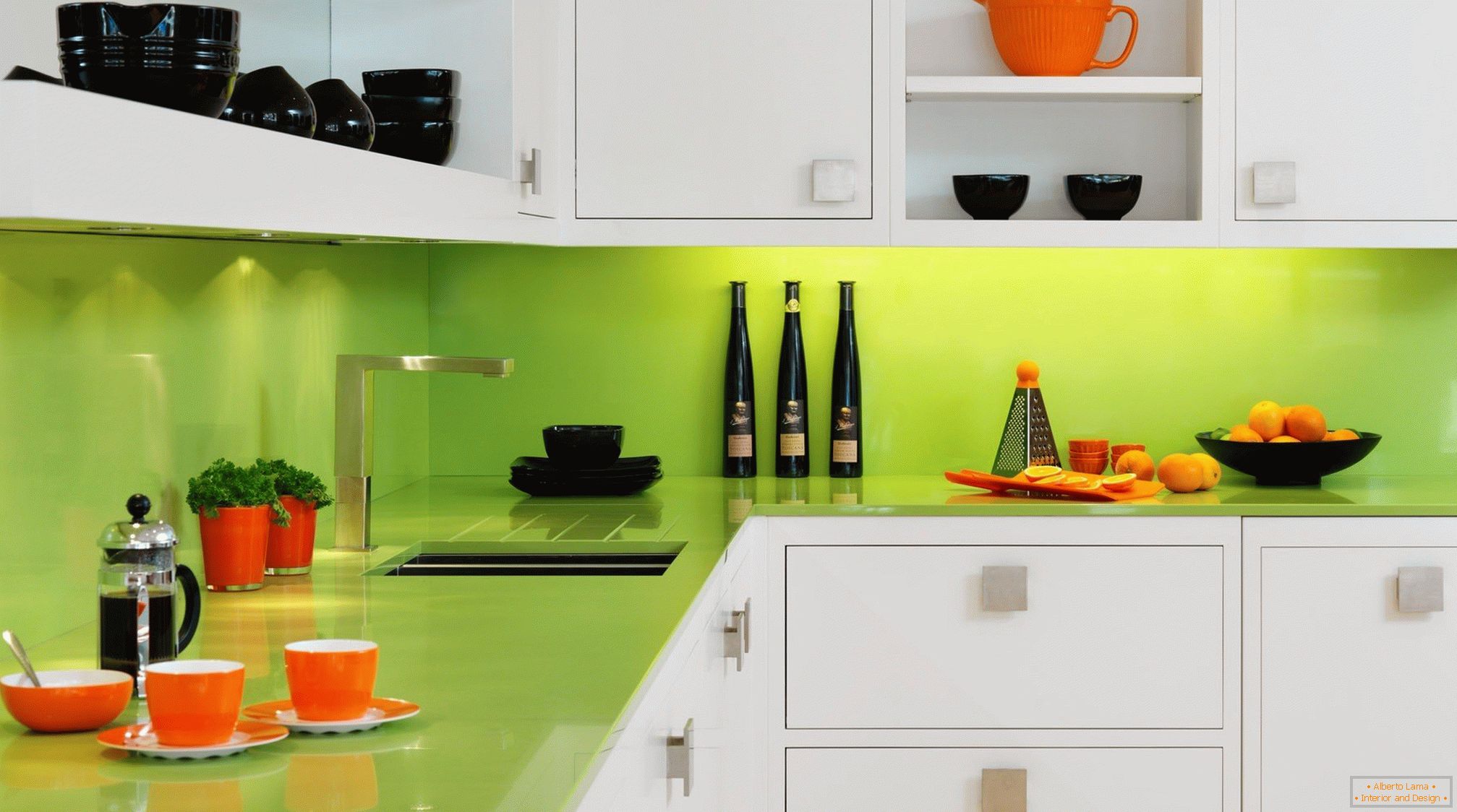 Orange and black dishes in a white-green kitchen