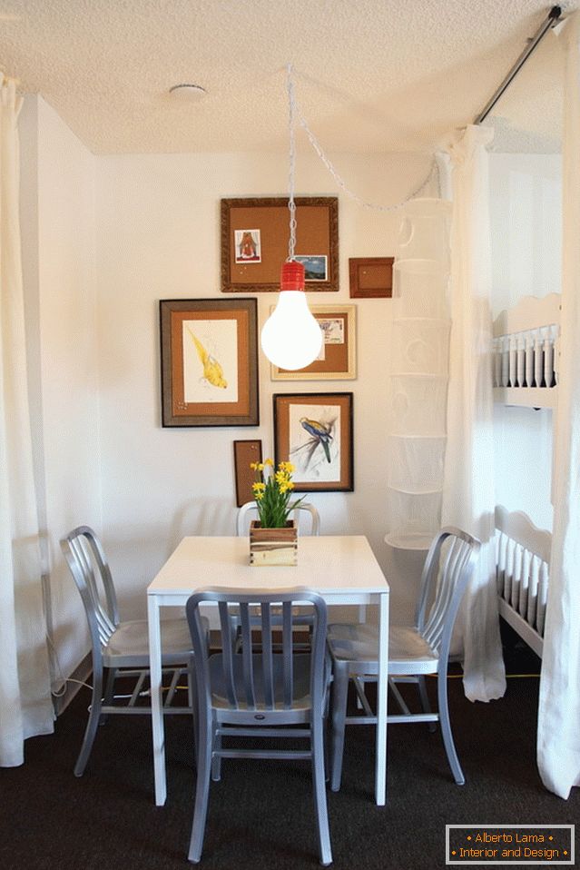 Paintings on the wall in a small dining room