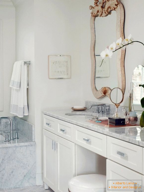White furniture and marble in the design of the bathroom