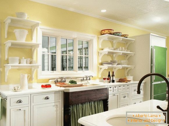 White furniture and green decor in the kitchen