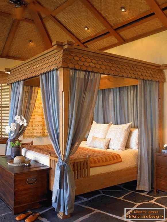 Wooden bed with rich decoration and canopy