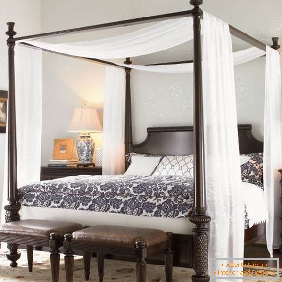 Thin white canopy over black bed
