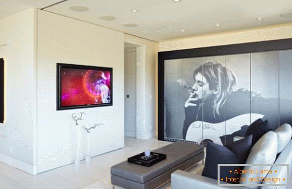 Interior of a small living room with portraits of celebrities