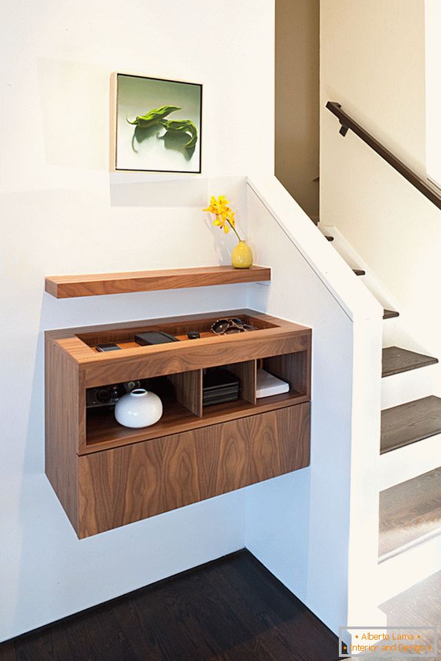 Suspended nightstand by the stairs