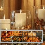 Candles in vases with nuts
