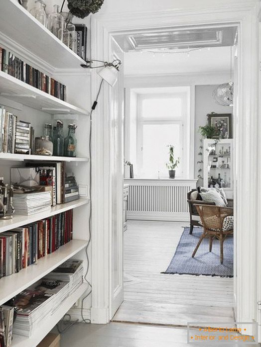 A small corridor with a library in Scandinavian style