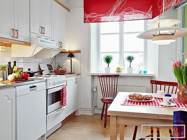 Red accents on the white kitchen