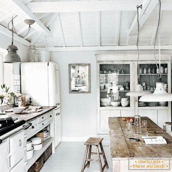 White kitchen in a wooden house