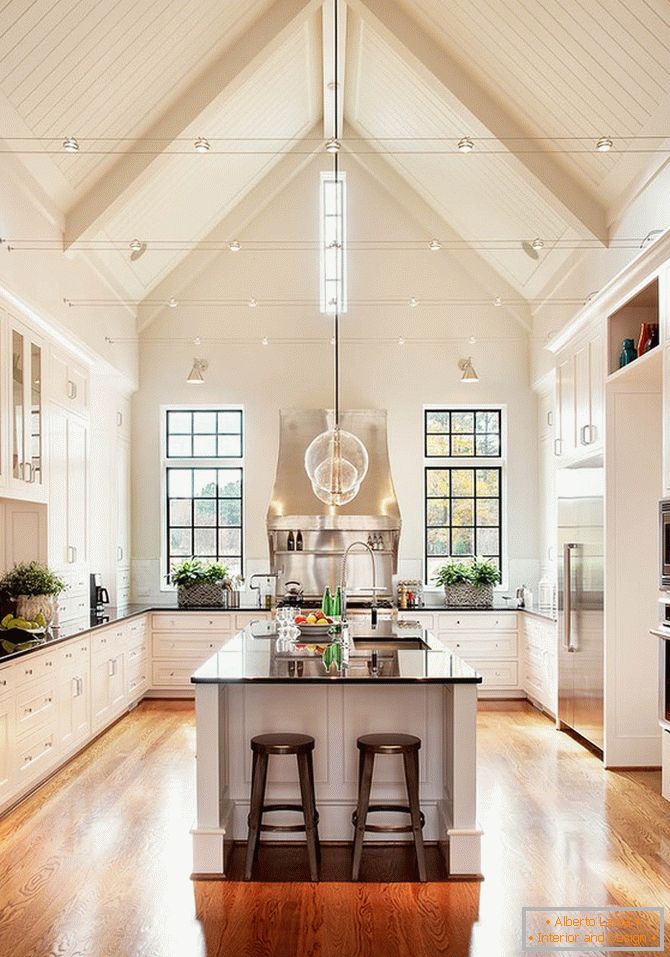 A huge kitchen in beige colors with wooden floors
