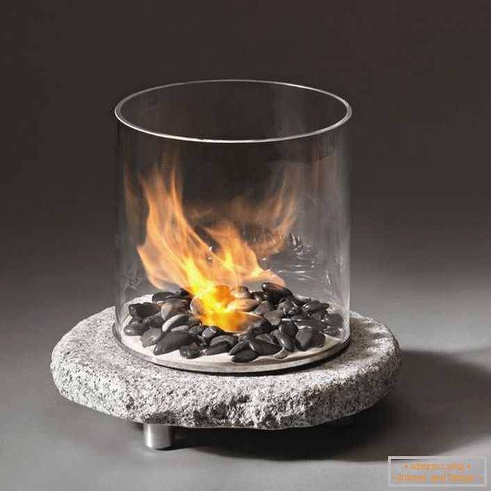 Decorative mini fireplace. Well, it's very much worth putting a red rose (fireproof) inside the glass.