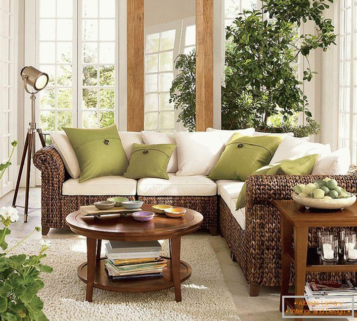 Large windows with wooden frames let in the living room in eco-style a sufficient amount of sunlight, which should prevail in the room.