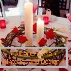Decoration of a table with candles and rose petals