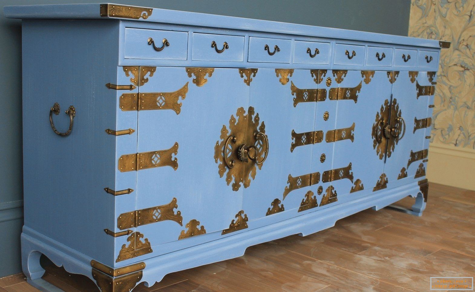 Blue chest of drawers with bronze decor