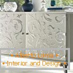 White chest of drawers with patterns