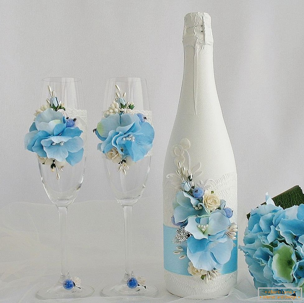 Decoration of wedding glasses and bottles with flowers