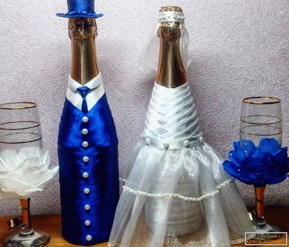 Wedding bottles in suits of the bride and groom