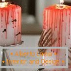 Bloody candles with nails and hands