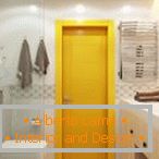 Yellow door in a bright bathroom