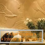Decorating walls with decorative plaster in the form of rose buds