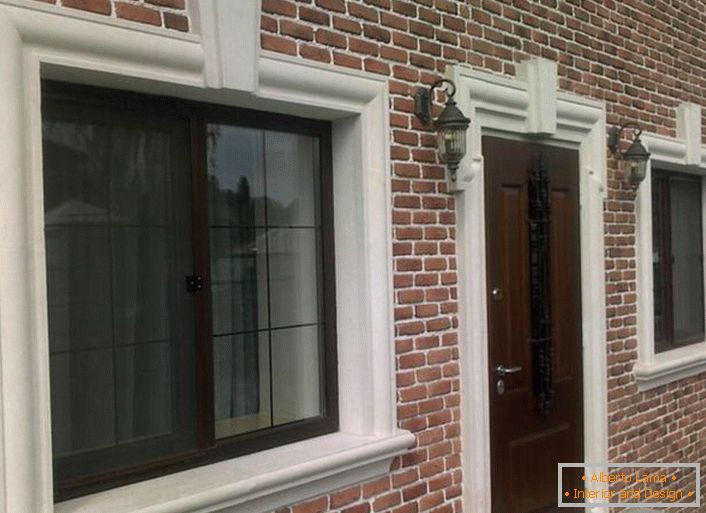 Brick masonry is organically combined with a facade molding, framing window and door openings.
