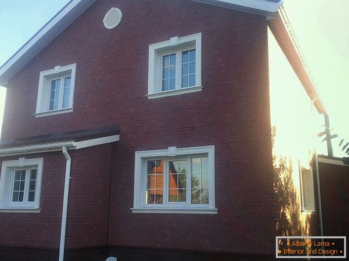 Ceramic stucco decorates the brick facade of a large house of a French family.