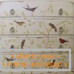 Pattern with birds on the branches on the chest of drawers