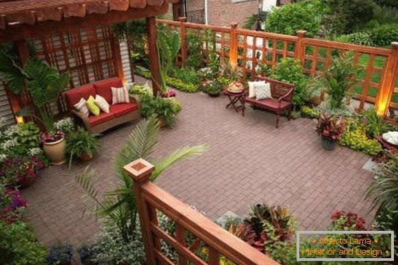 Modern design of the courtyard of a private house - a terrace with flowers