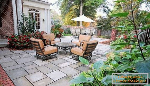 Table and chairs in the design of a small courtyard of a private house