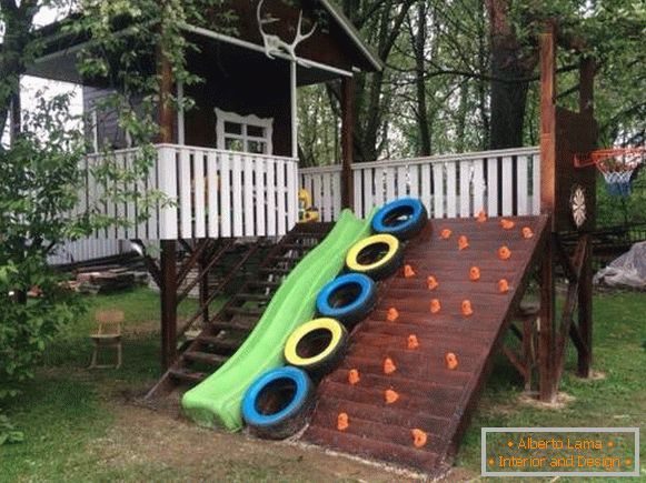 Design of a yard in a village with a playground - photo