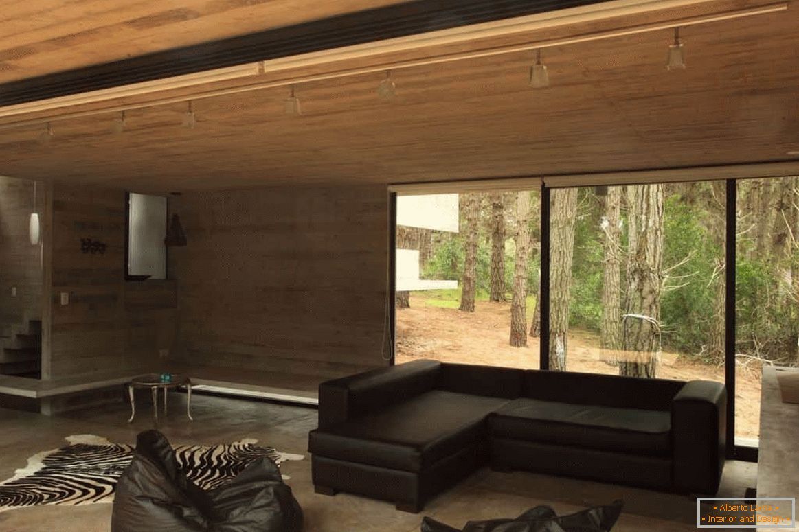 Living room with a wood finish in a wooden house with a panoramic window