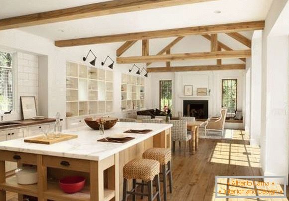 Interior design of a country house - a photo of a combined kitchen with a living room