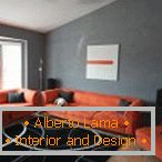 Orange furniture in a gray room