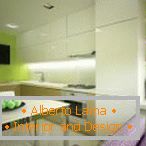 White furniture and light green walls in the kitchen