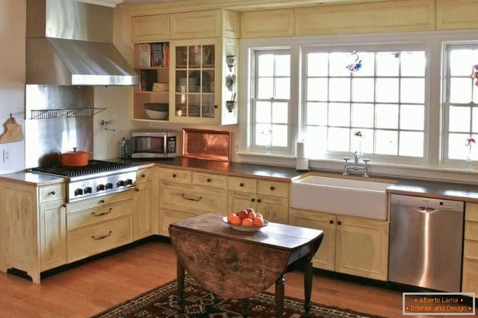 Large corner kitchen in light colors in a rustic house