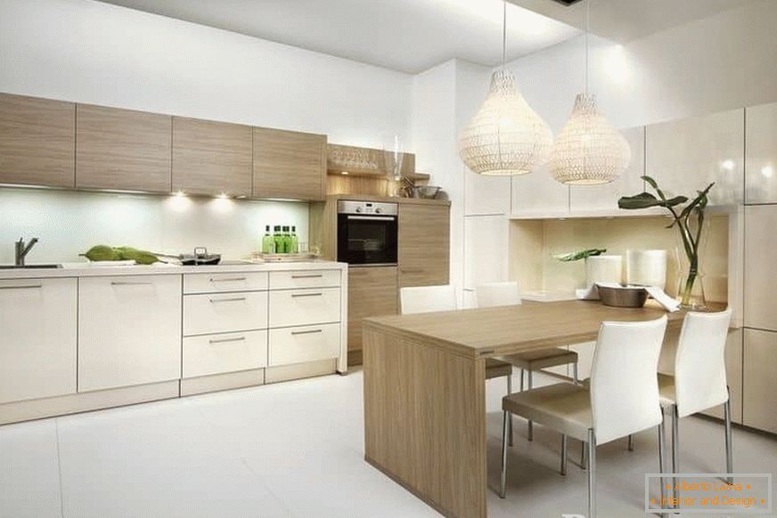 Modern kitchen design in light colors with a dining area