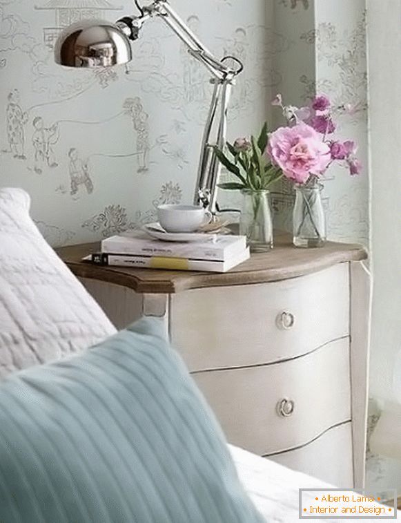 Flowers and books on the bedside table