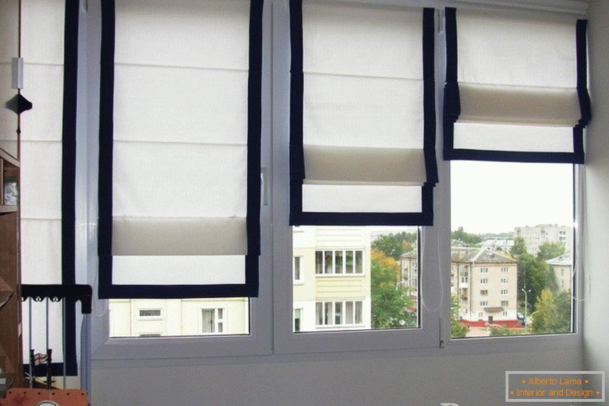 White curtains with black fringing on the windows