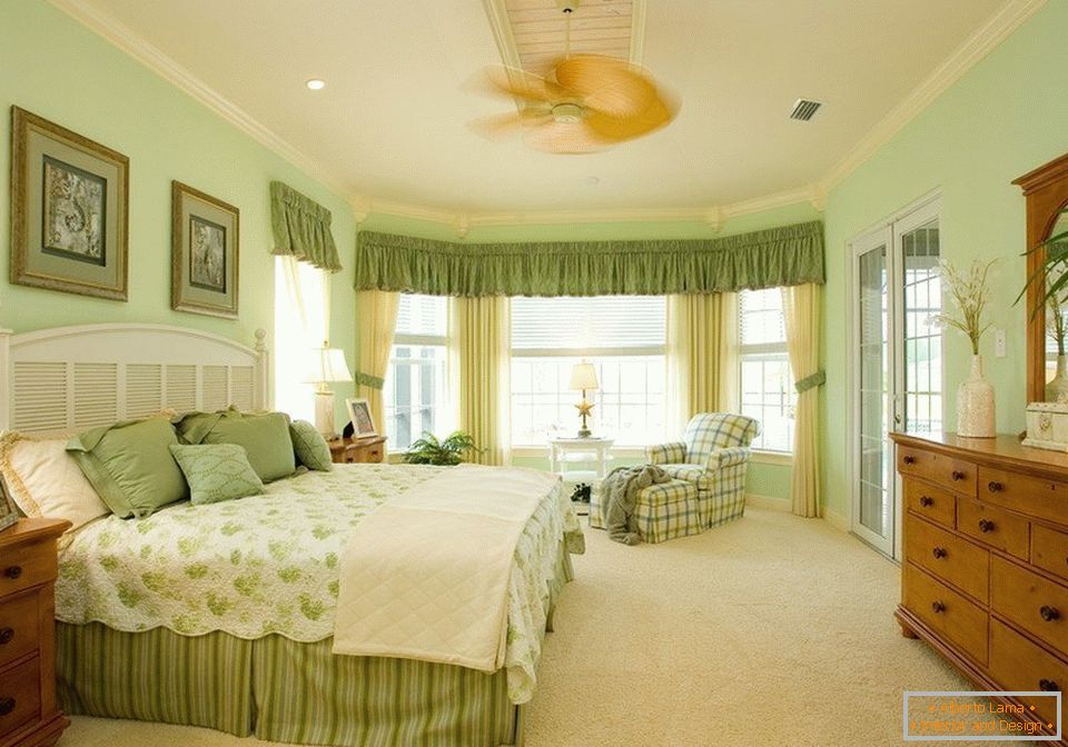 Interior of a spacious bedroom in green colors
