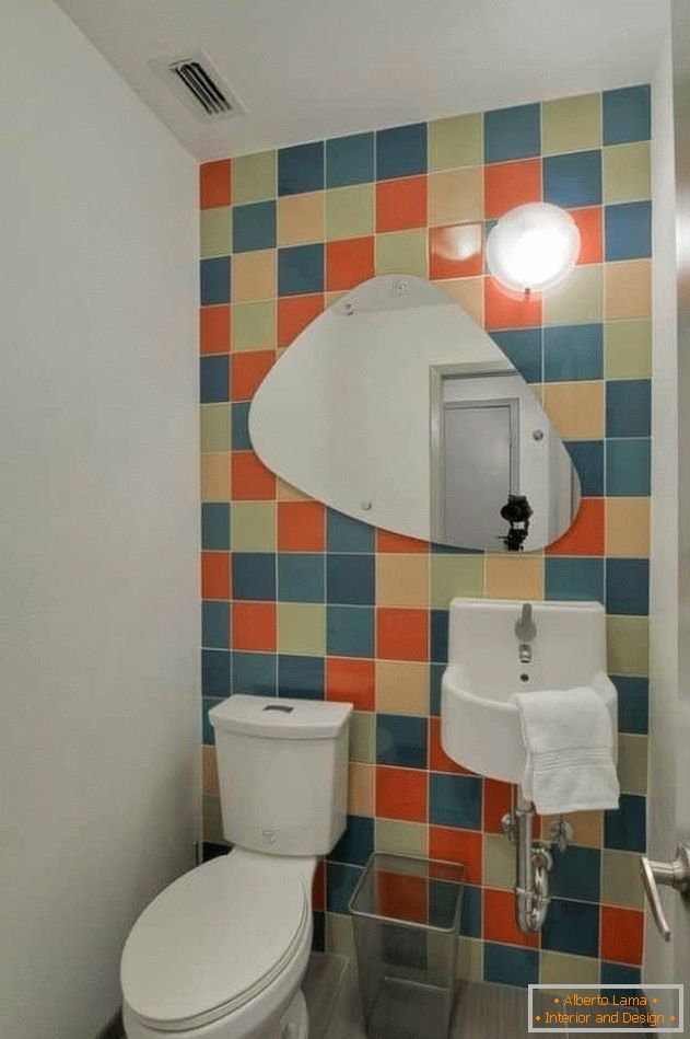 Small toilet with bright tiles and painted walls
