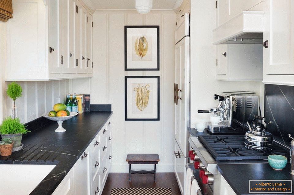 A long kitchen with a black table top