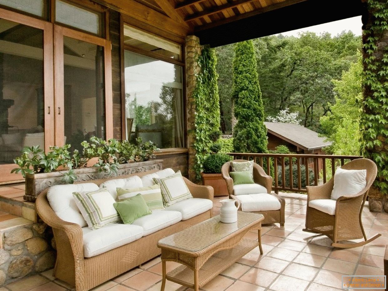 Wooden furniture with white pillows on the veranda