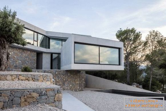 Building a house in the style of high-tech and concrete and stone