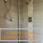 An insert of natural stones in the design of a shower room