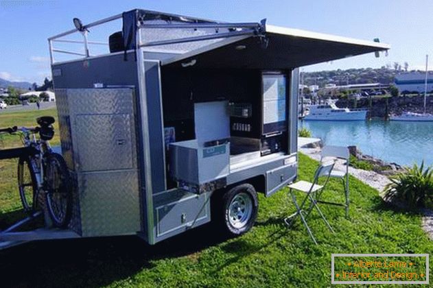 Mini-house on wheels on the river bank