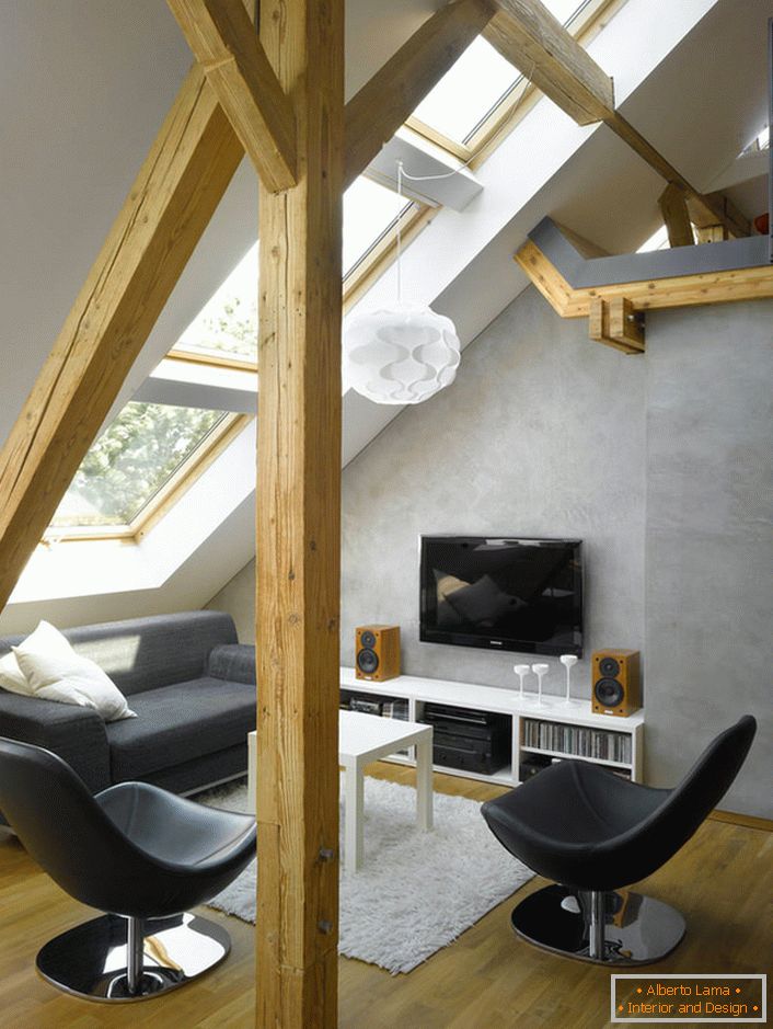 A small living room in a chalet-style mansard is a great place for a secluded holiday.