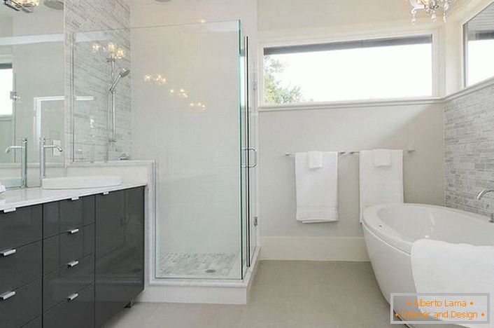 A spacious modernist bathroom with the right lighting is decorated by the famous designer of France. 