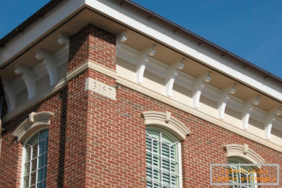 Beautiful facade stucco under the roof of the house in the photo