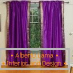 Room with purple curtains on the window